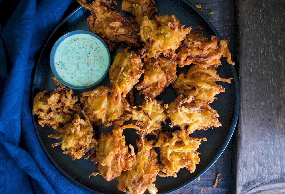 A crispy, deep-fried snack made from vegetables or meat,